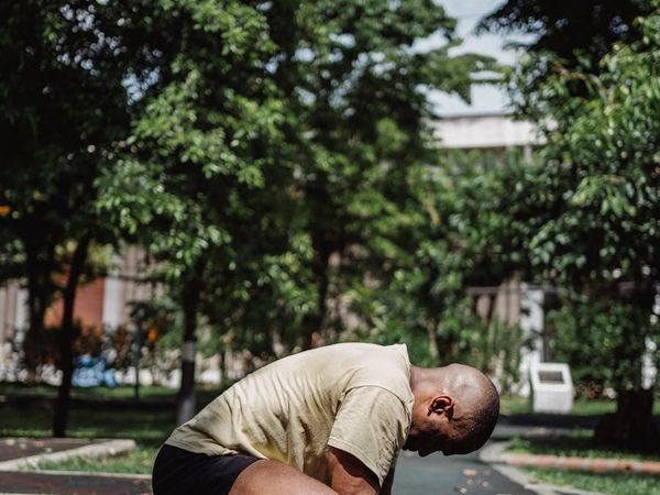 A man carefully performing a bodyweight squat, with lines emphasizing correct posture.